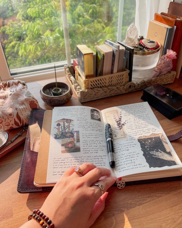 aesthetic day in my life story hand writing in a journal with a pen on a desk with fairy lights