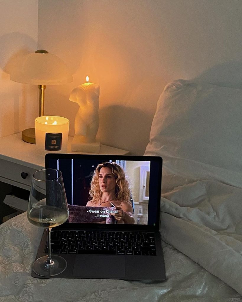 aesthetic day in my life story person in pajamas lighting a candle in bedroom at night