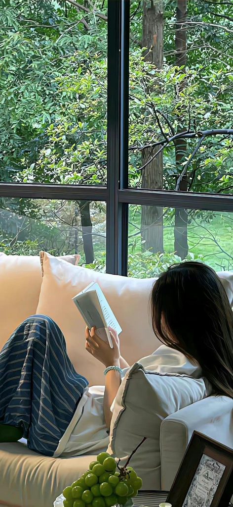 aesthetic day in my life story woman reading a book in cozy chair with blanket and sunlight
