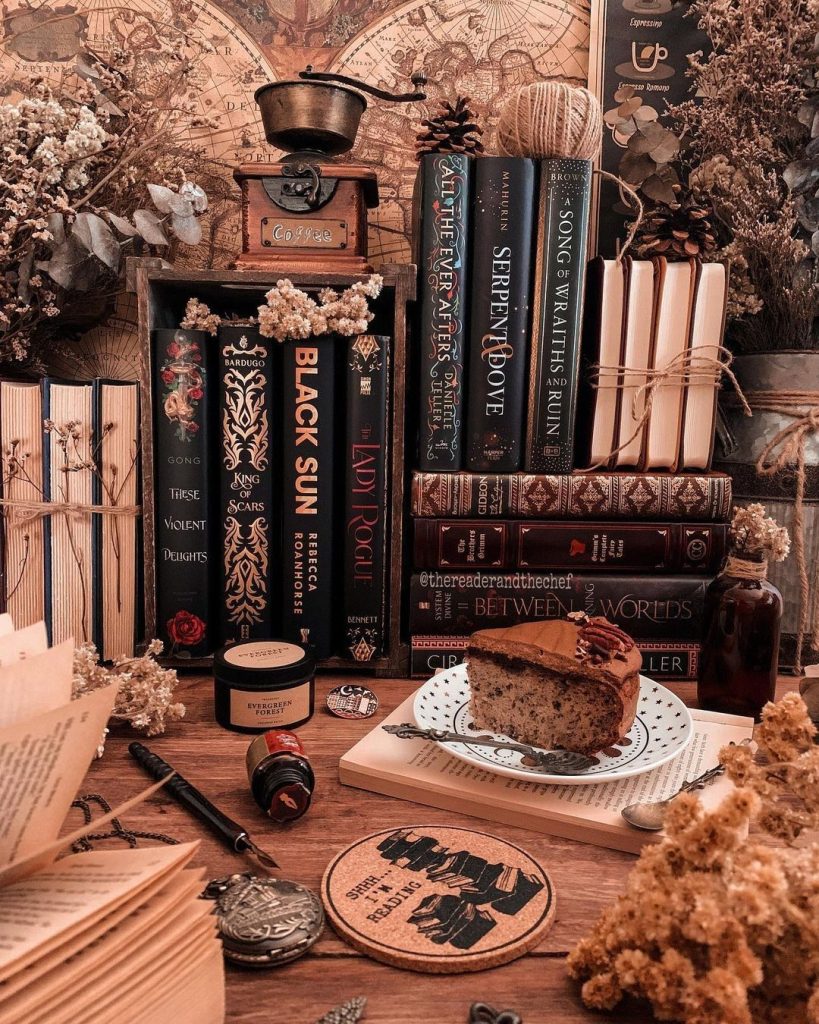 aesthetic lifestyle blogger story aesthetic book stack on a wooden table with fairy lights