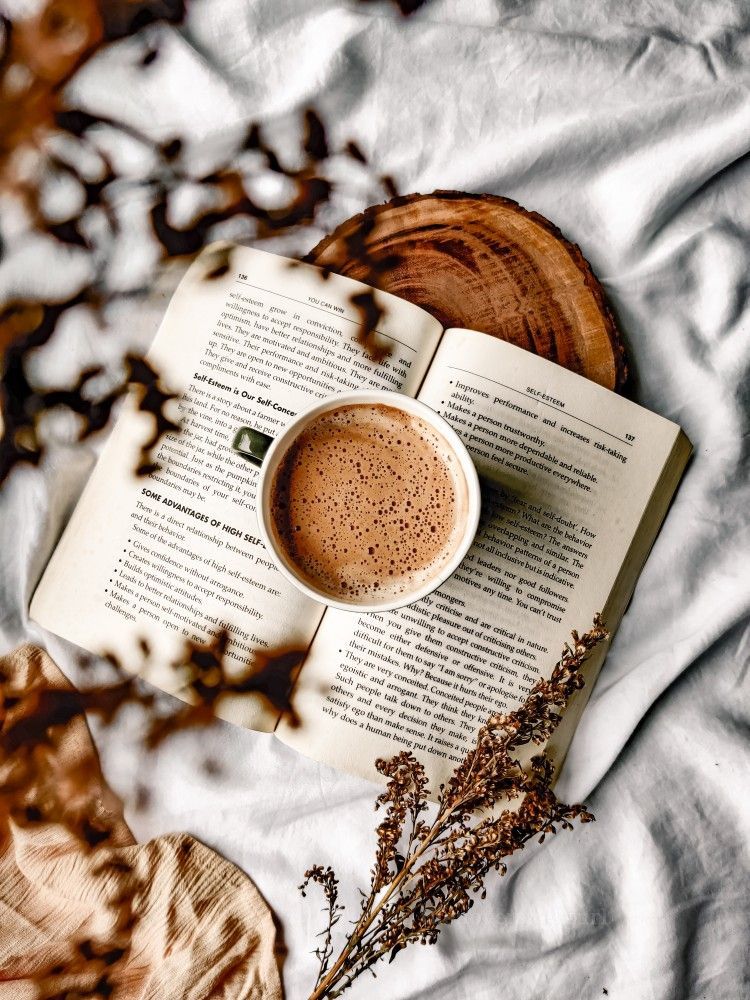 aesthetic lifestyle blogger story aesthetic coffee table flat lay with coffee cup, book, and fresh flowers