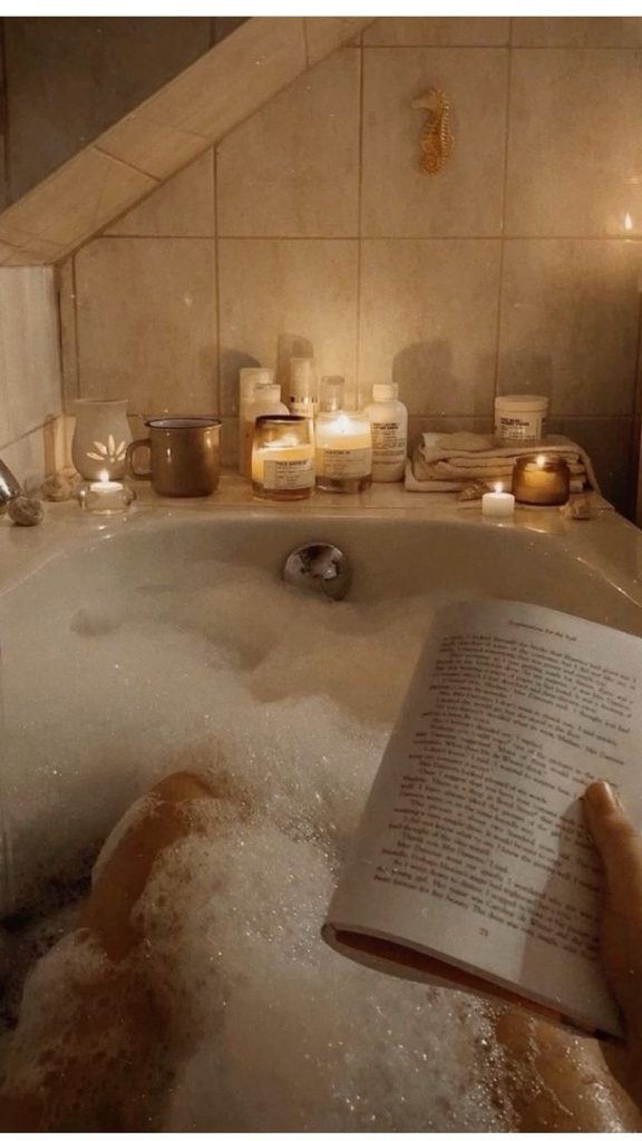 aesthetic lifestyle blogger story aesthetic self-care setting with candles, bath salts, and a towel