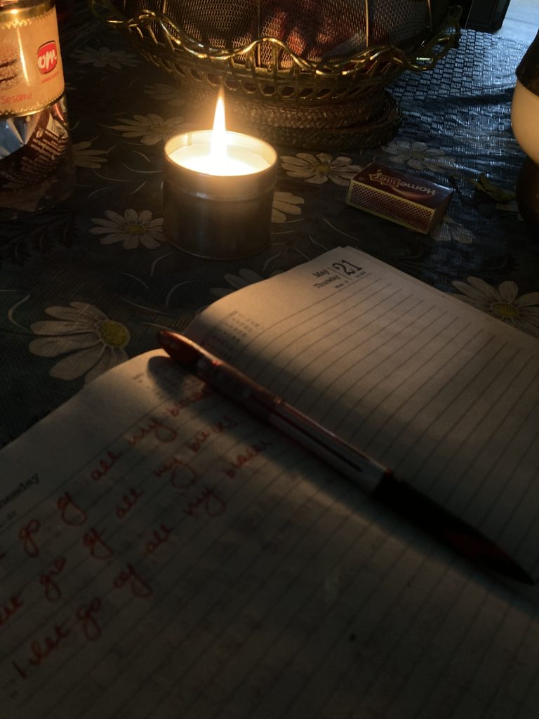 aesthetic night routine story open journal with pen and fairy lights on wooden desk